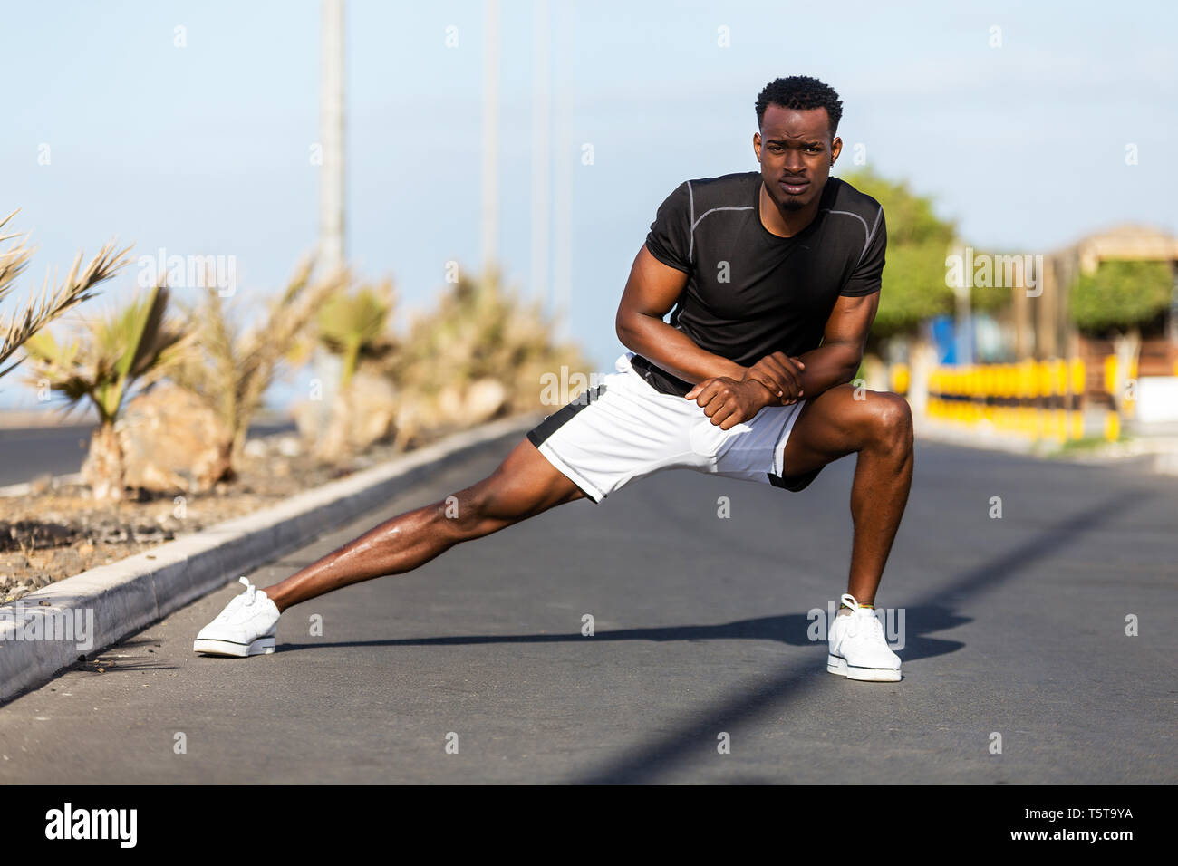 Black african american young man stretching after outdoor jogging Stock ...