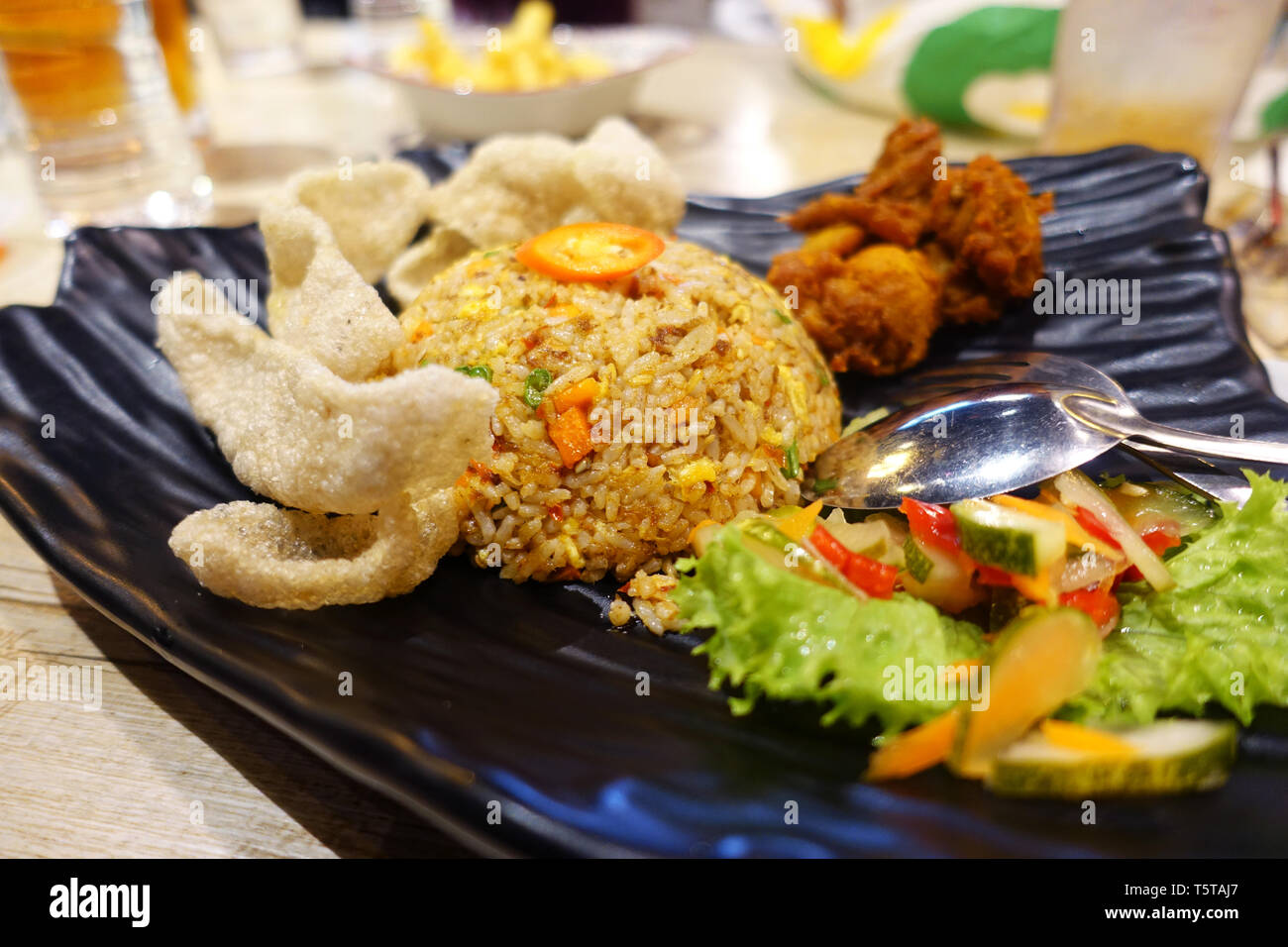 Fried rice with fish crackers and fried chicken with salad Stock Photo