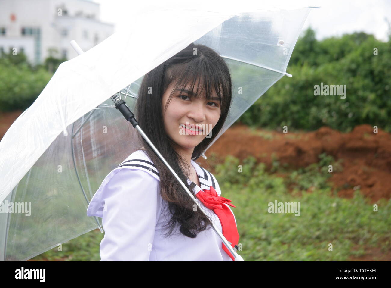 photo of a girl using a sun umbrella Stock Photo