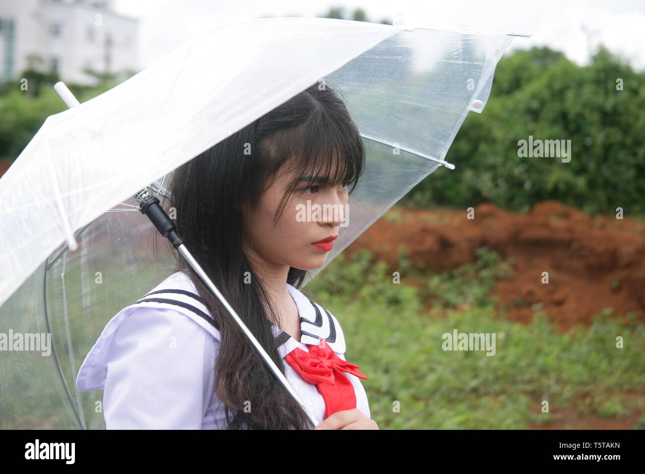 photo of the girl using the umbrella and pondering Stock Photo - Alamy