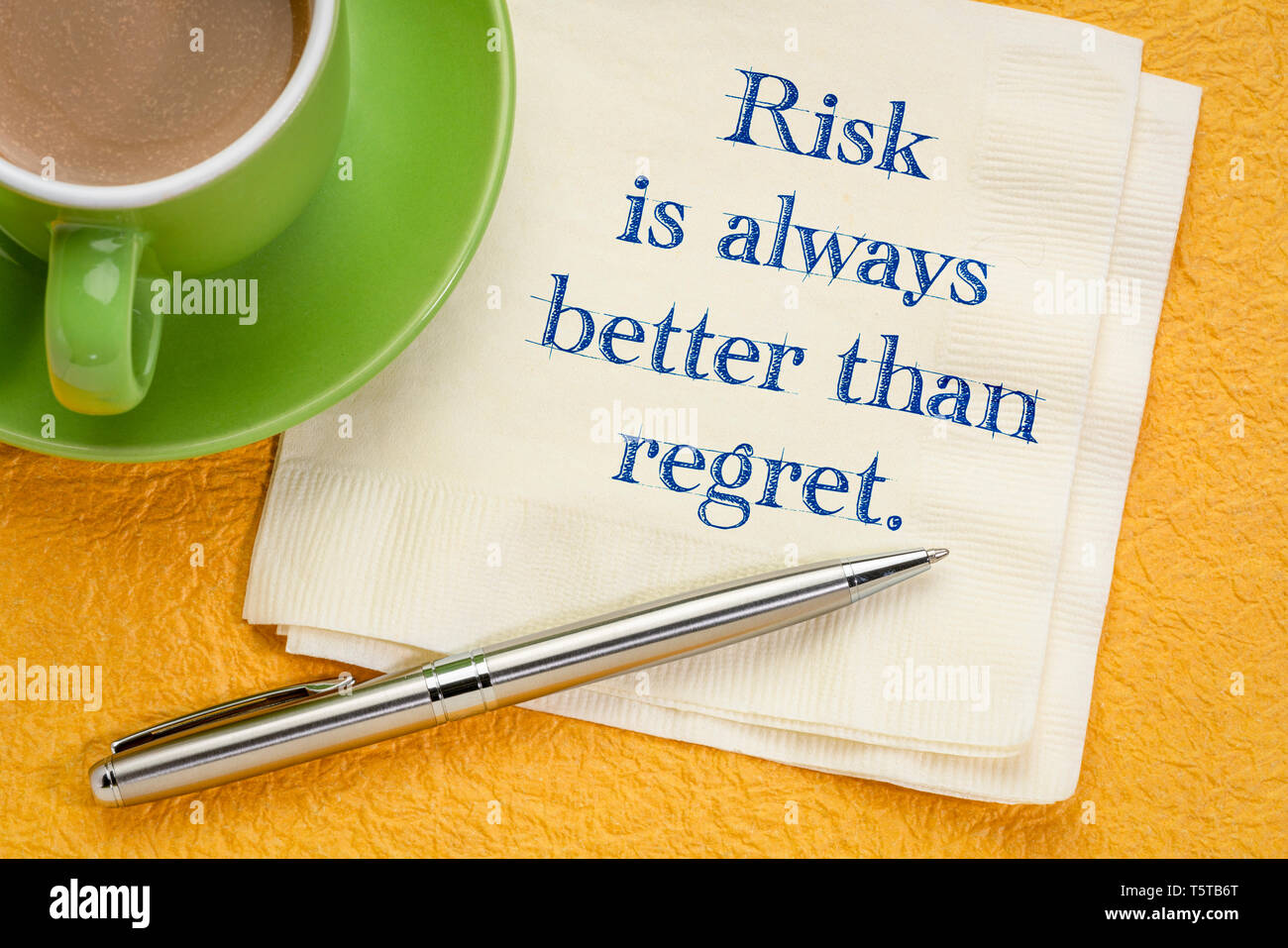risk is always better than regret - inspirational handwriting on a napkin with a cup of coffee Stock Photo