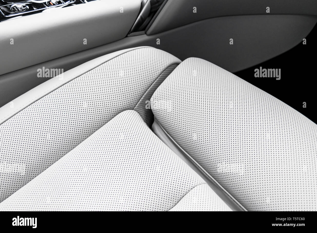 White leather interior of the luxury modern car. Perforated white