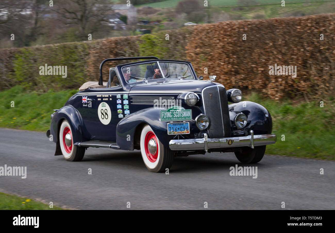 A 1937 Cadillac Convertible climbs Southwaite Hill in Cumbria, England. The car is taking part in the 11th Flying Scotsman Rally, a free public-event. Stock Photo