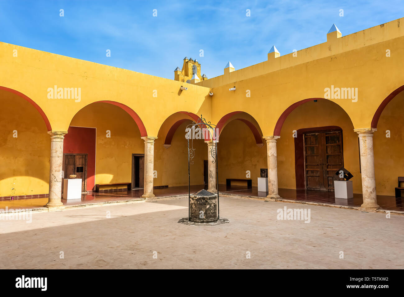 Vivid yellow colonnade under blue skies in Mexico Stock Photo
