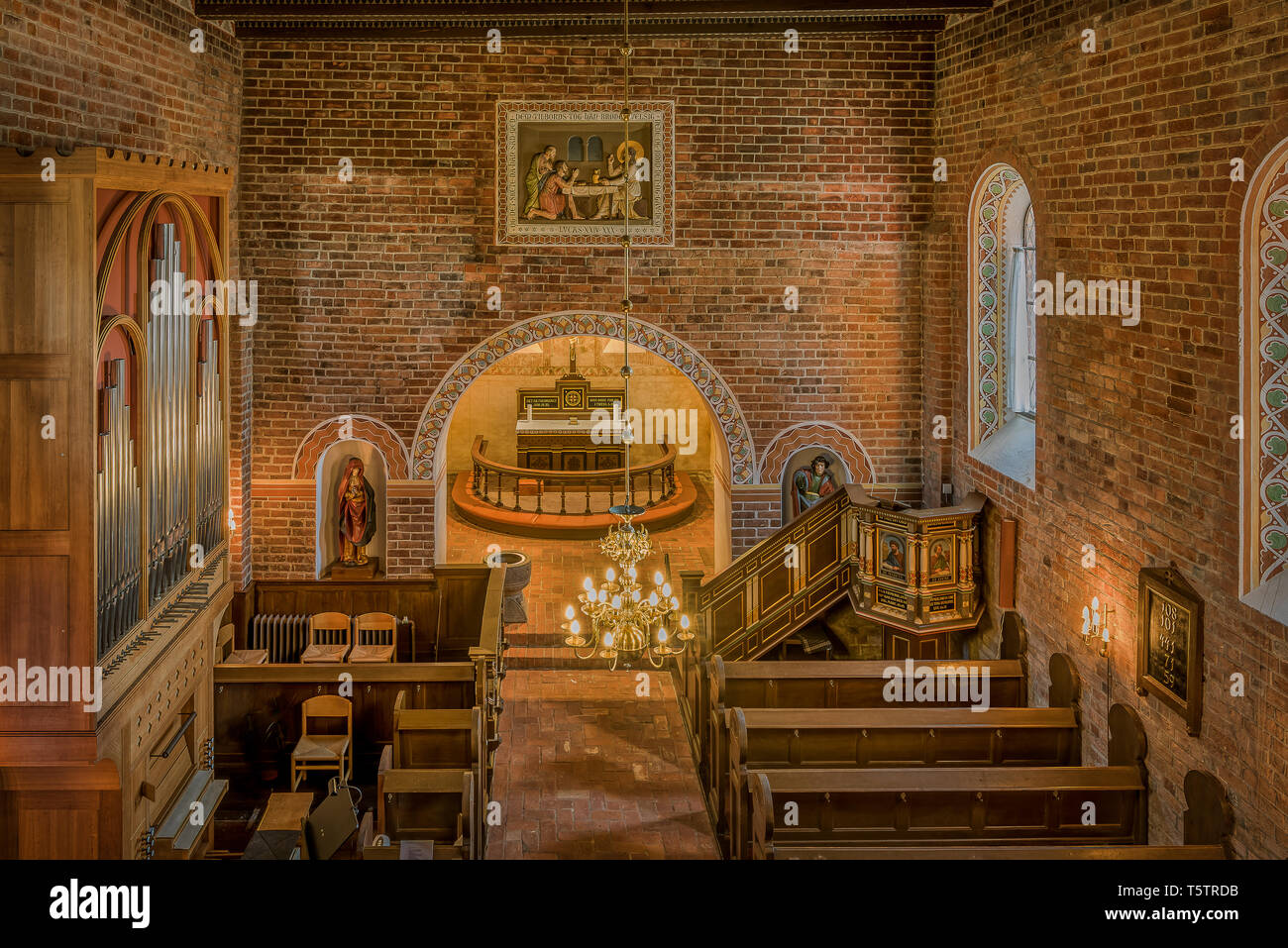 Interior of a soft and warm medieval danish brick church, Tirsted, Denmark,  April 17, 2019 Stock Photo
