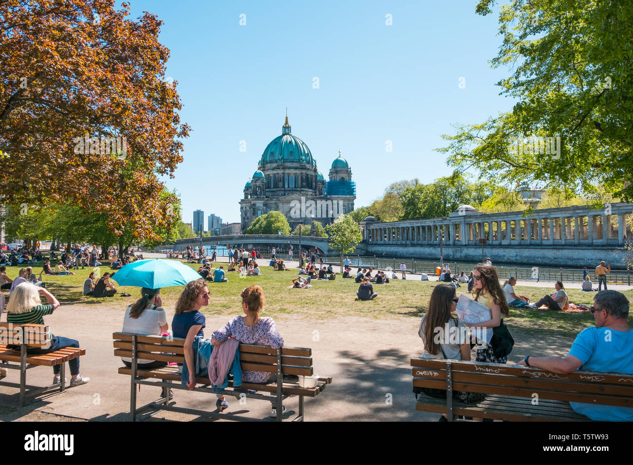Berlin, Germany - April, 2019: People in public park on a sunny day near Museum Island and Berlin Cathedral Stock Photo