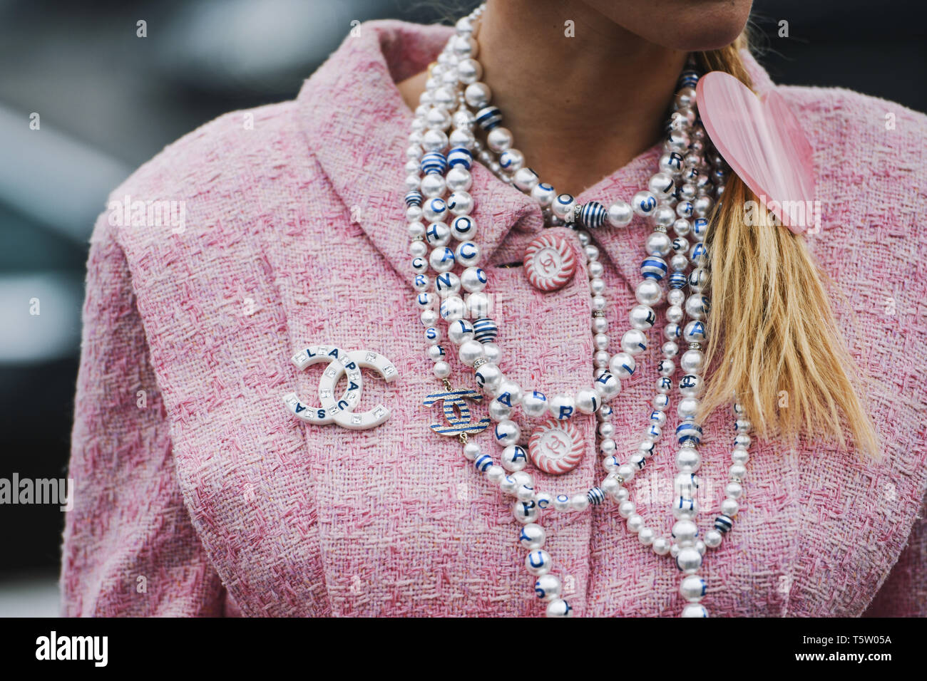 Paris, France - March 5, 2019: Street style - Woman wearing Chanel outfit before a fashion show during Paris Fashion Week - PFWFW19 Stock Photo