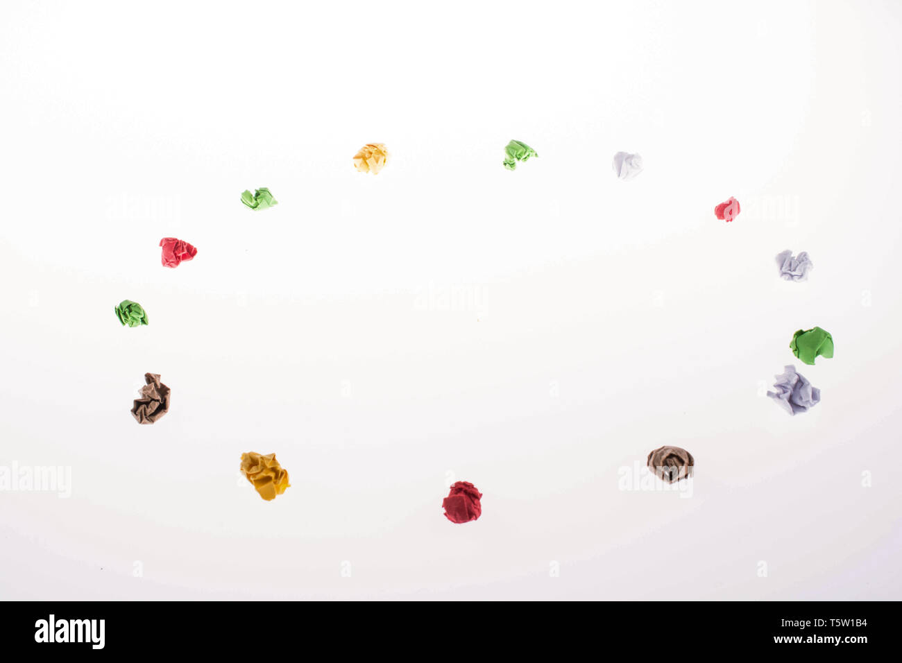 Colorful crumpled papers form a round shape on white background Stock ...