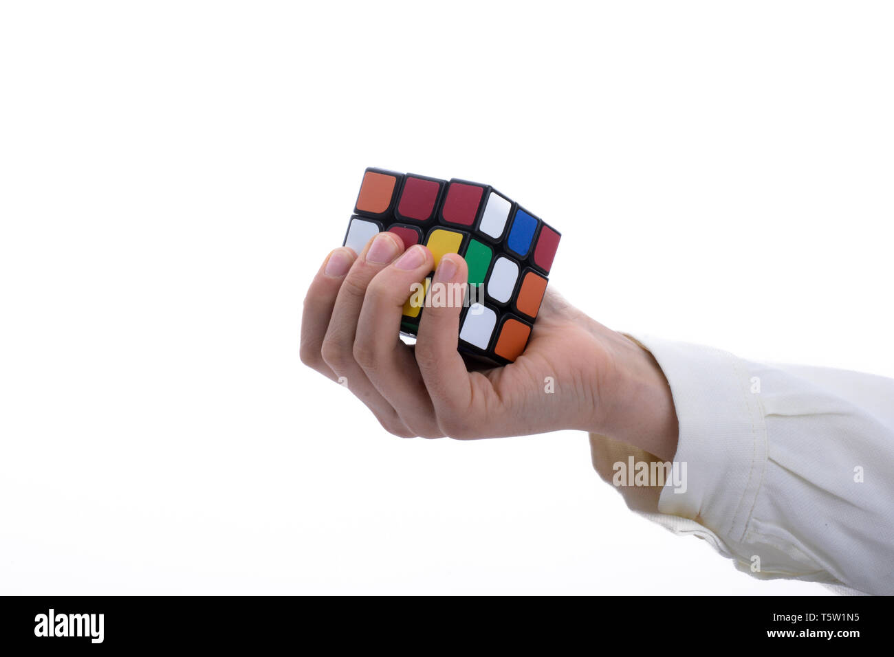 Child holding a Rubik's cube in hand on a white background Stock Photo ...