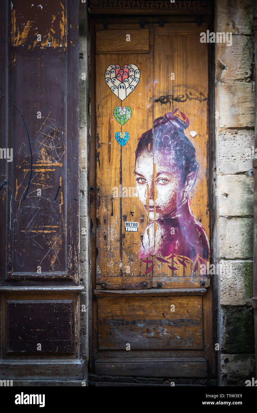 Tagged woman portrait Audrey Hepburn style on the door of a Bordeaux shop Stock Photo