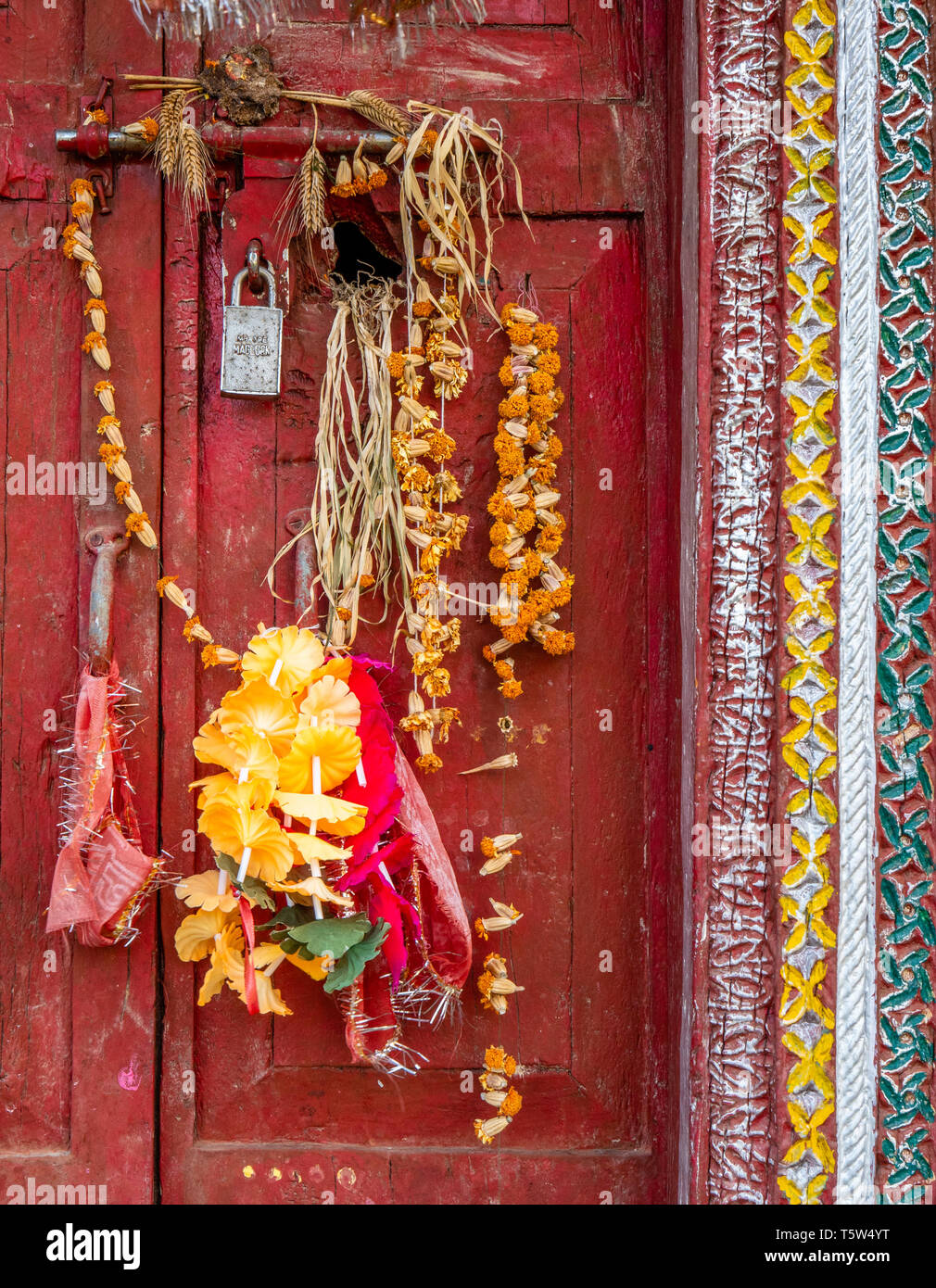 Elaborately decorated doors and windows of the principal house in Supi village high up in the Saryu Valley of the Uttarakhand Himalayas northern India Stock Photo