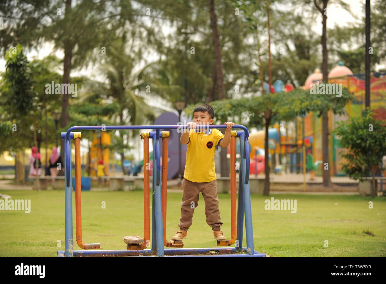 A boy Playing at the Coastarina Beach, Batam Island Stock Photo