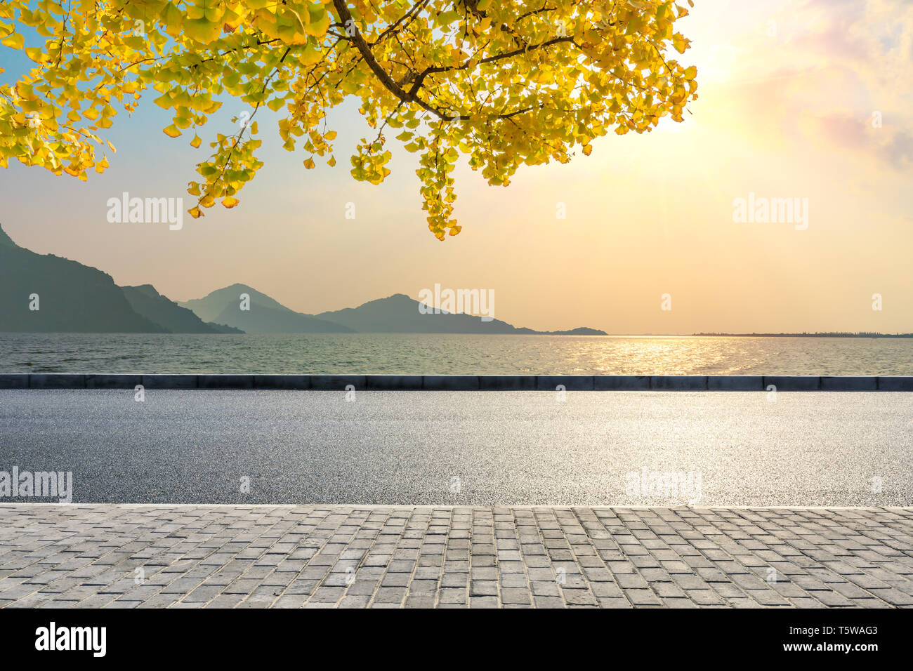 Empty asphalt road and river with mountain landscape Stock Photo