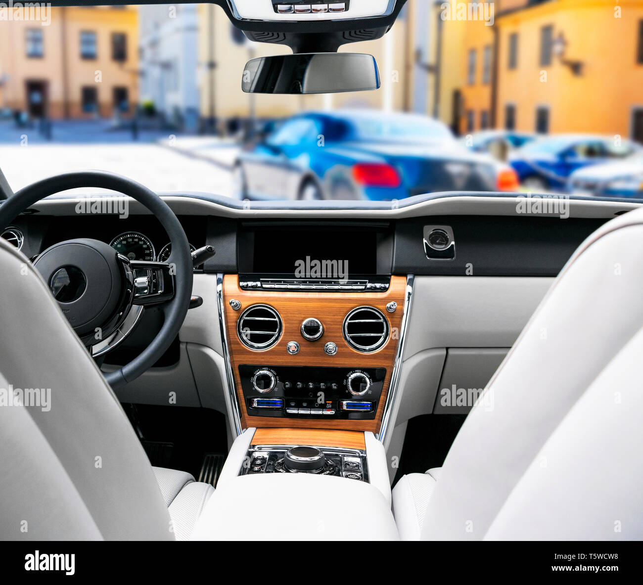 Modern luxury car white leather interior with natural wood panel. Part of leather car seat