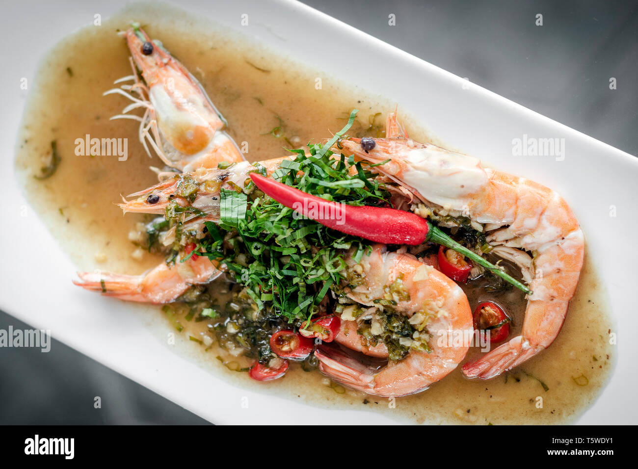 spicy asian prawns in gourmet chilli orange and coriander sauce in