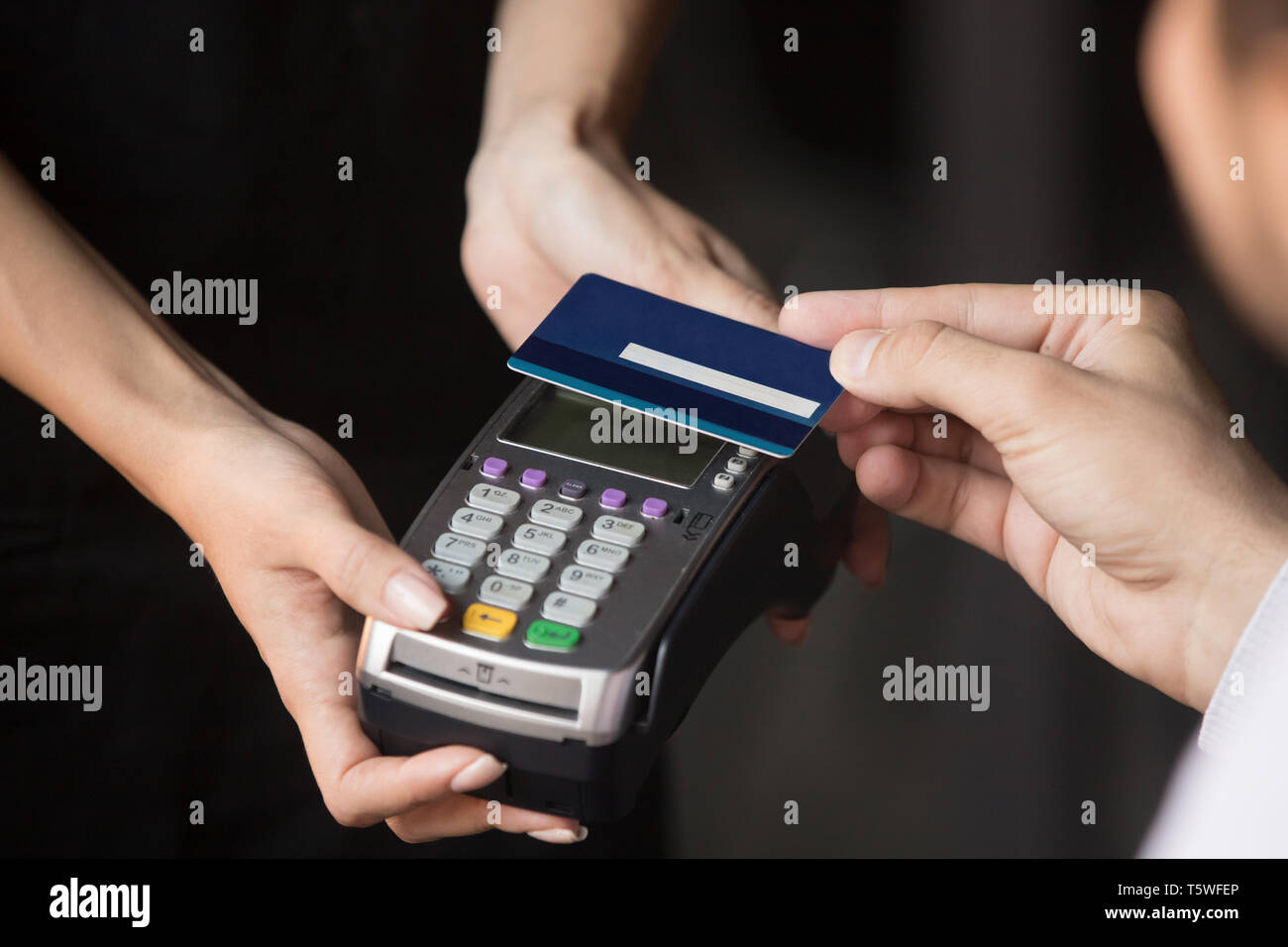 Customer paying in cafe with credit card use NFC technology Stock Photo