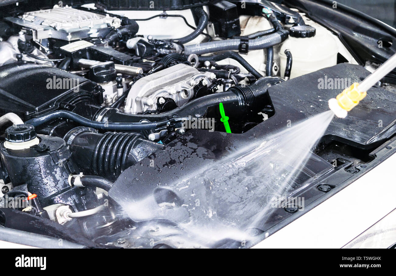 Car detailing. Manual car wash engine with pressure water. Washing car