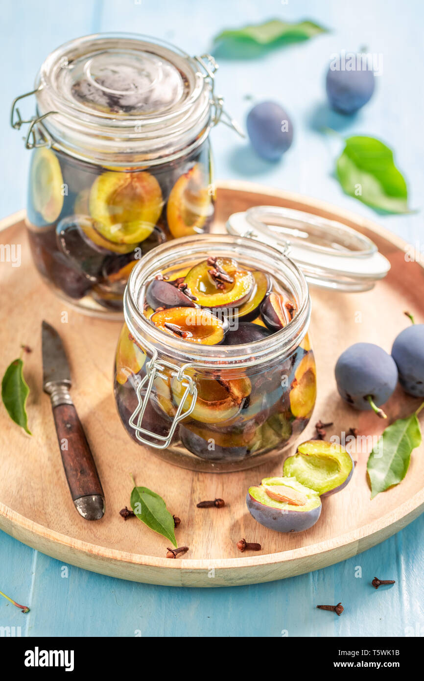Preparation for pickled purple plums in the jaron blue table Stock ...