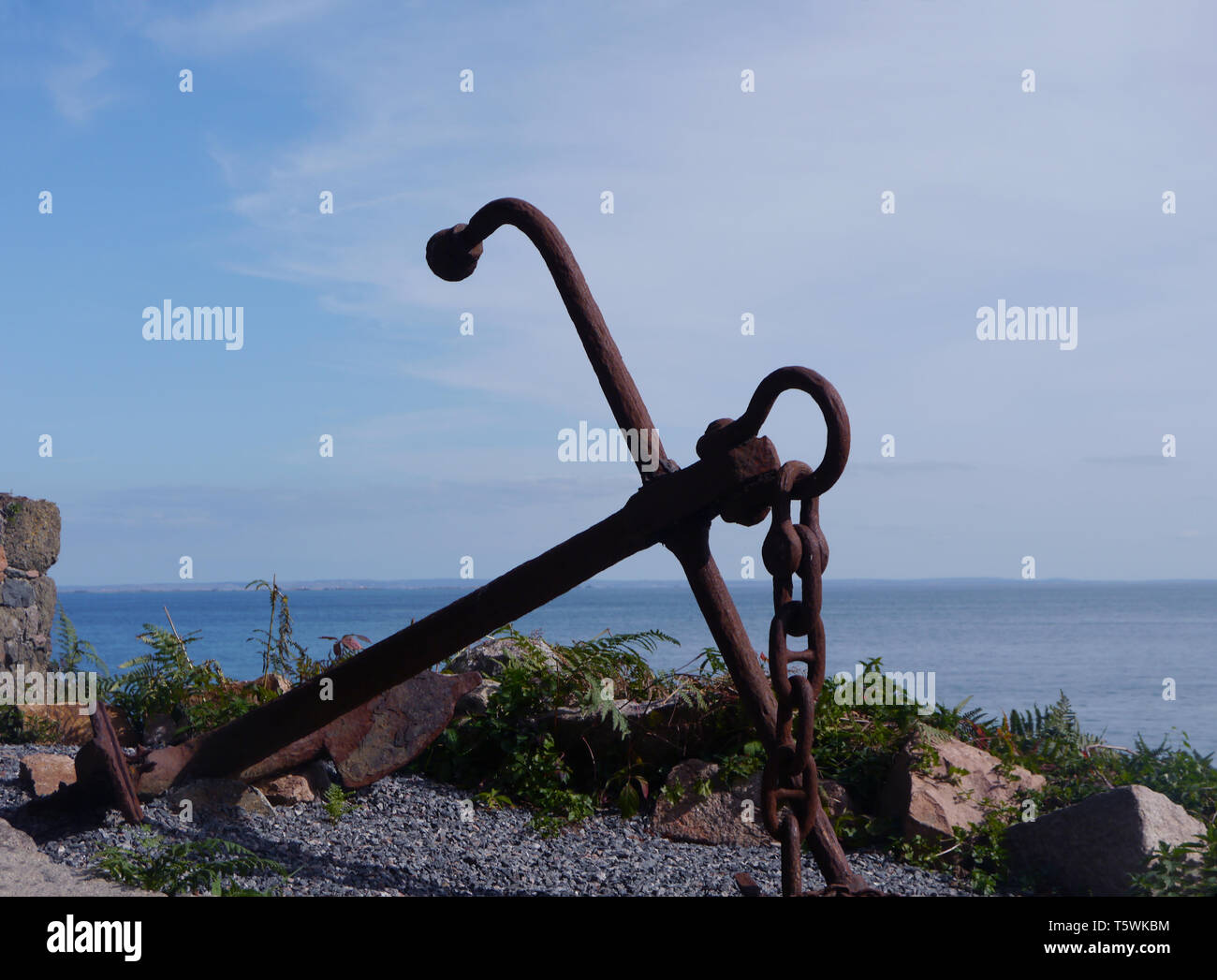 A Old Rusty Iron Anchour Outside the Restored Fortress at Fliquet Bay on the Island of Jersey, Channel Isles, UK. Stock Photo
