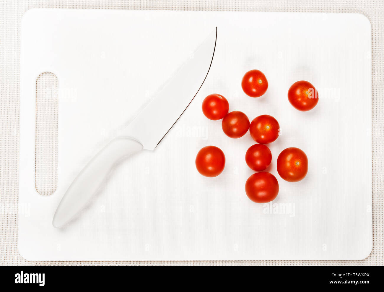 white cutting board,white knife and red cherry tomatoes Stock Photo - Alamy
