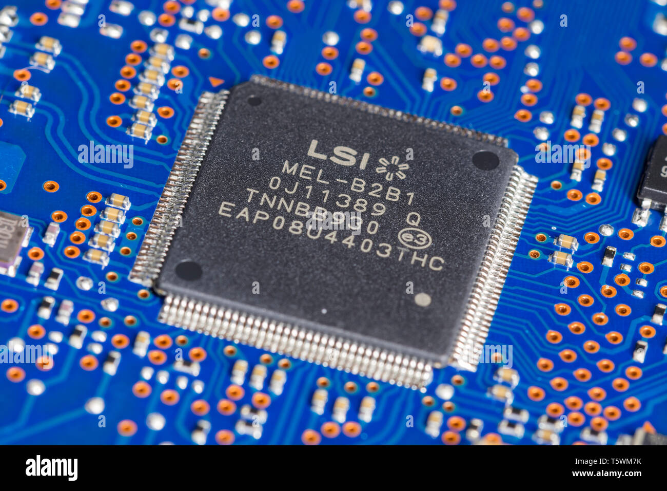 LSI Quad Flat Pack package type of surface mount technology (SMT) chip mounted on a PCB. Stock Photo