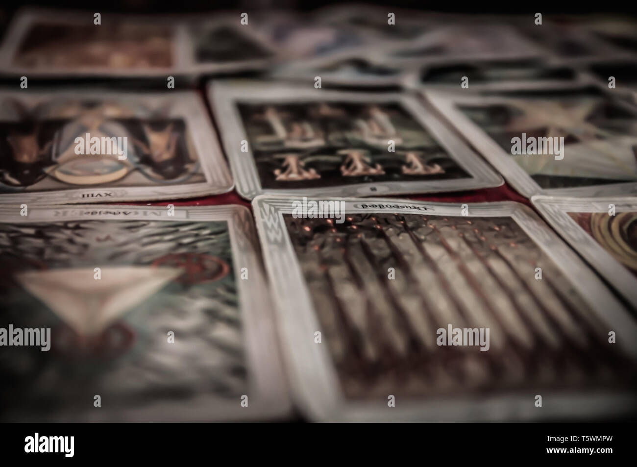 BRUVOLL, NORWAY - MARCH 23, 2011: Closeup of occult mystic tarot deck and old tarot cards laying on table for a magical pagan psychic destiny reading  Stock Photo