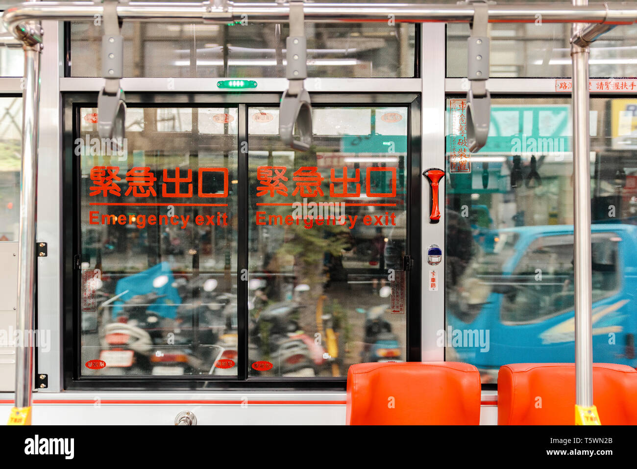 Emergency exit in Taiwanese Bus while driving on the street with hammer  hanging used to break glass during the emergency Stock Photo - Alamy