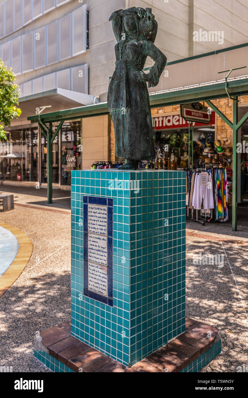 Darwin Australia - February 22, 2019: The bronze Water Bearer statue on the mall downtown, created by sculptor Irene Kokkinos. Commercial street scene Stock Photo