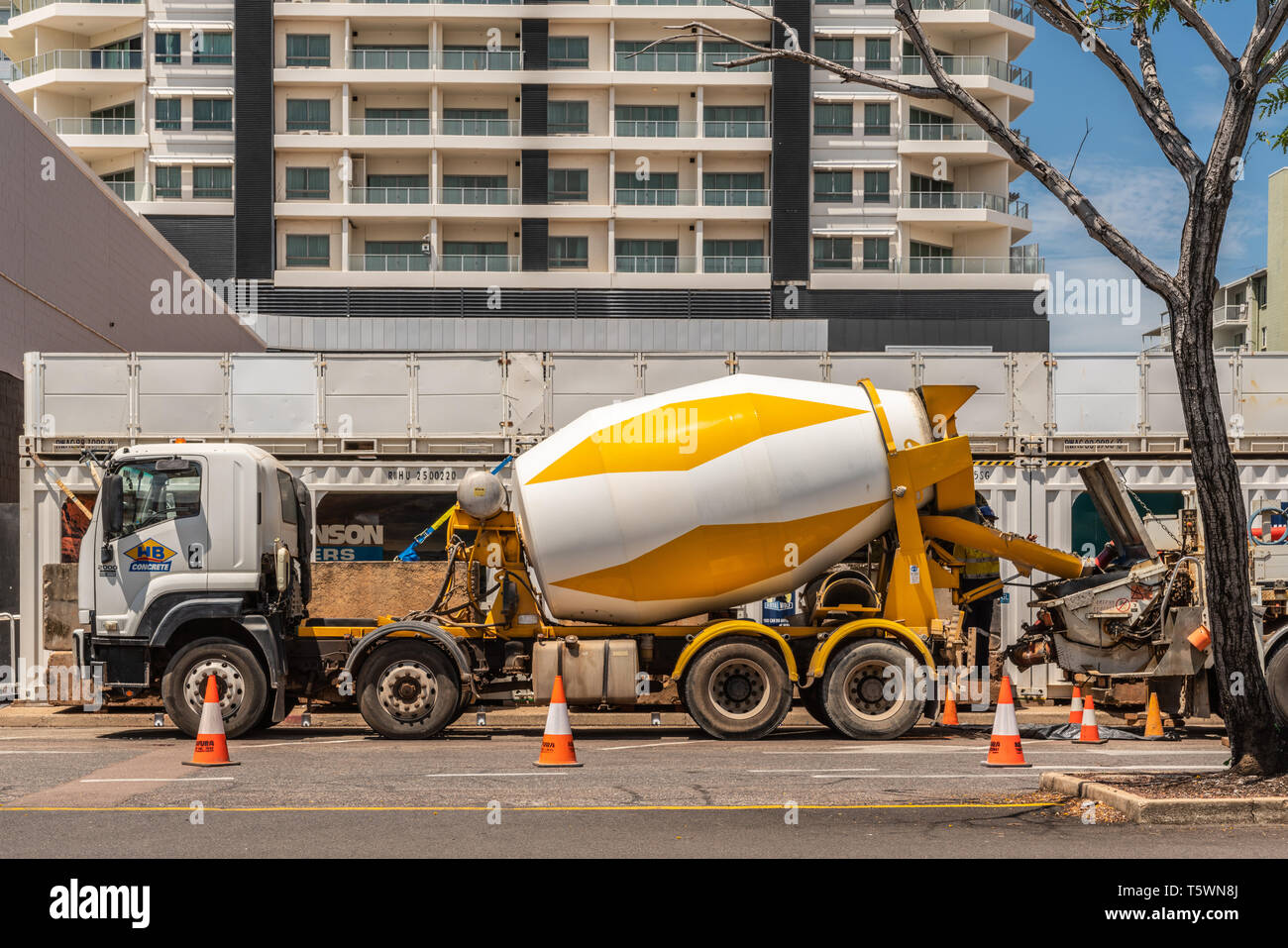 Darwin Australia - February 22, 2019: White and yellow concrete cement mill truck unloading its product, parked in Cavenaght Street downtown.  Highris Stock Photo