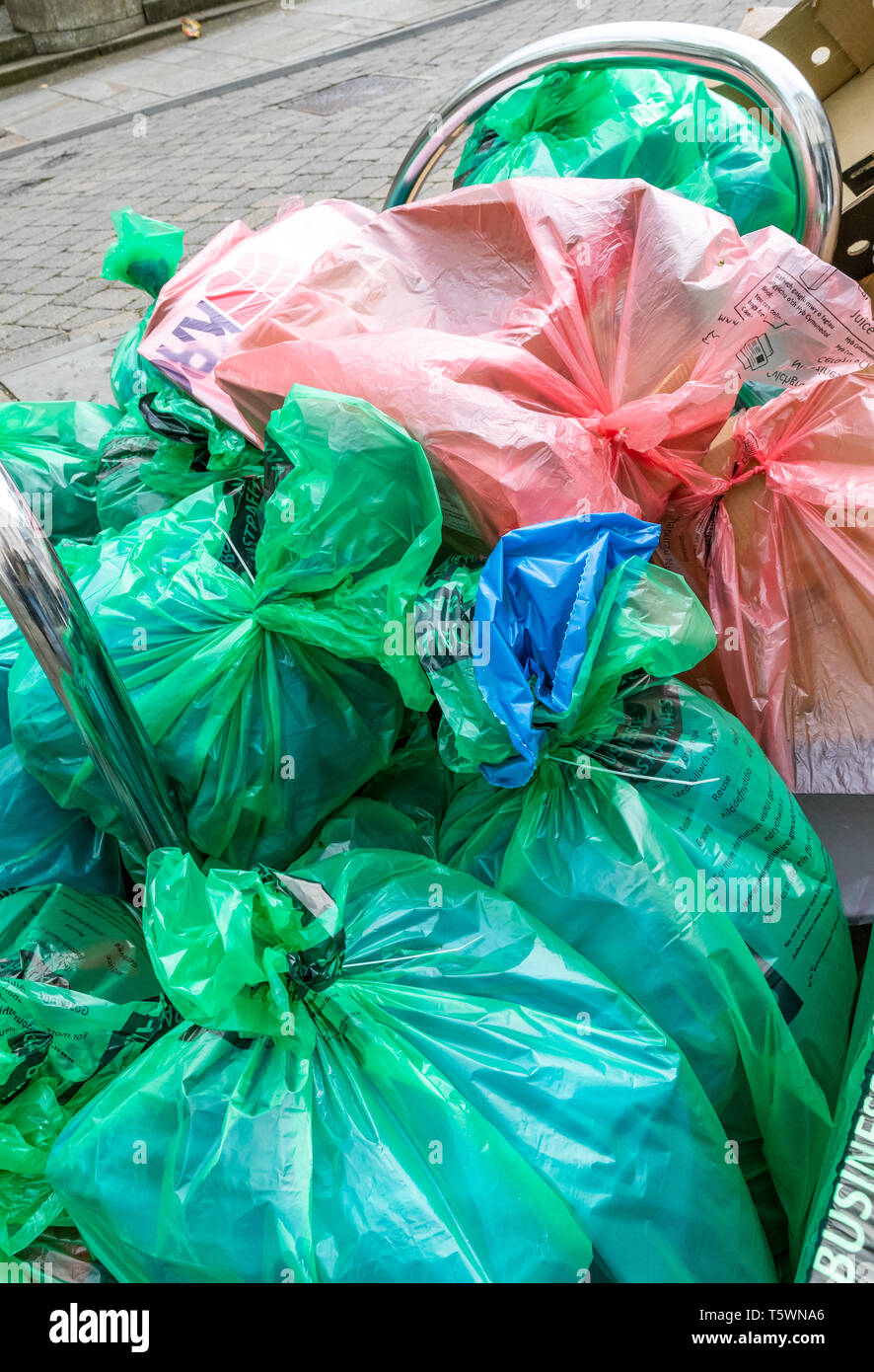 Commercial rubbish collection using plastic bags is piled in the street