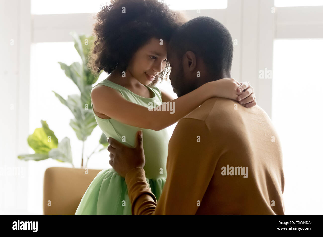 Mixed race little adorable daughter embrace loving father Stock Photo -  Alamy