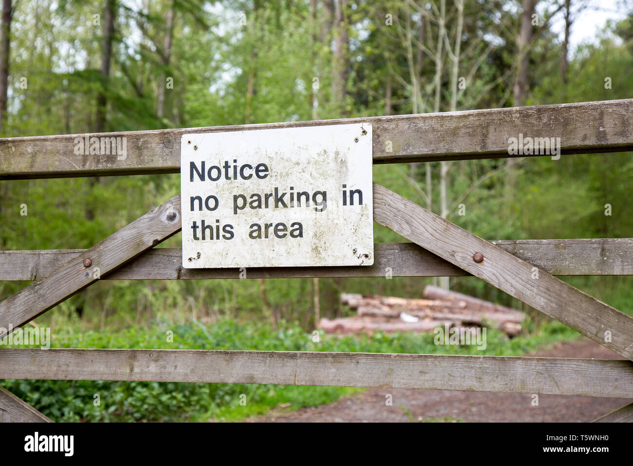 No Parking sign on wooden gate outdoors in UK woodland due to forestry