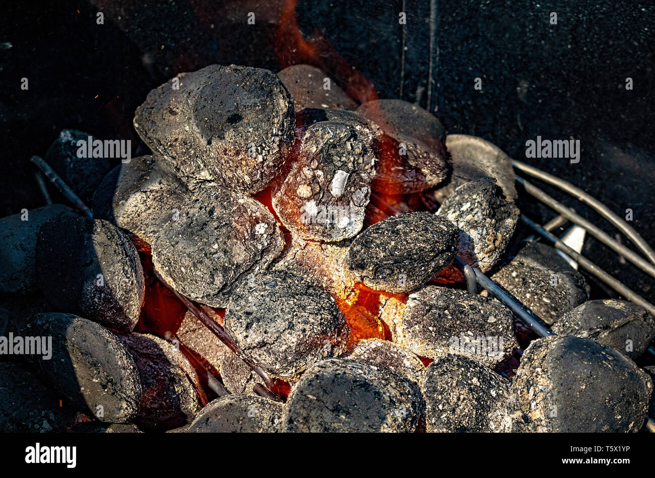 Hot barbecue coals being fired closeup background Stock Photo