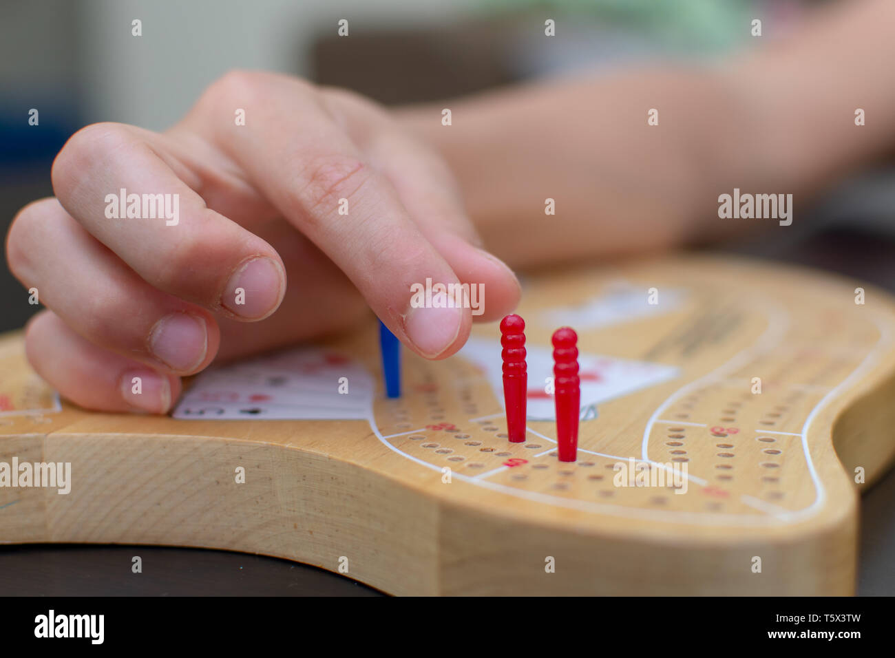 RAK, RAK/UAE 4/20/2019 "Child's hand moving a red peg in a Cribbage