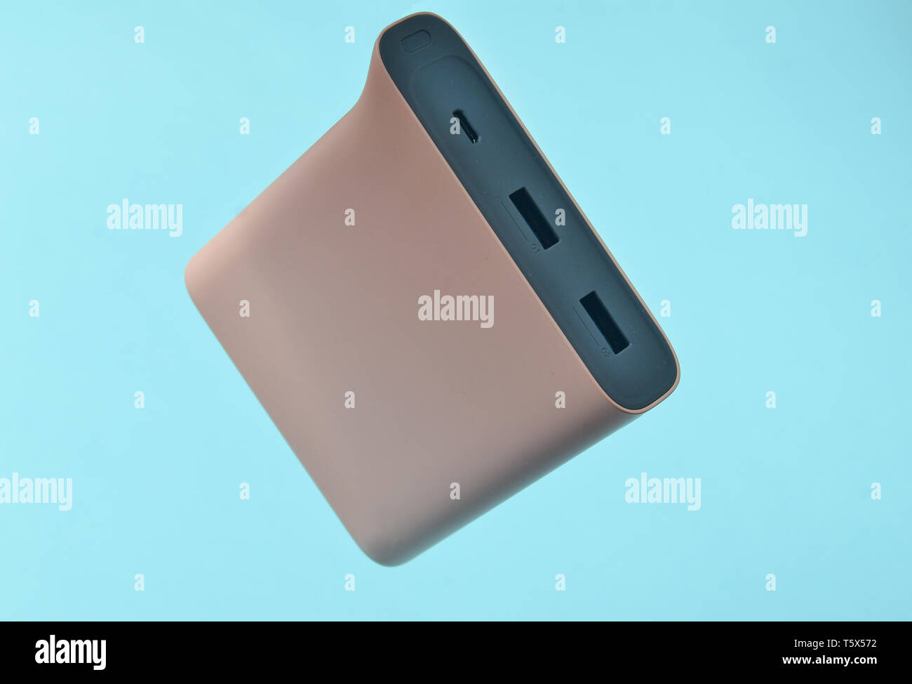 Power Bank Pale Pink Color On A Blue Background External Battery