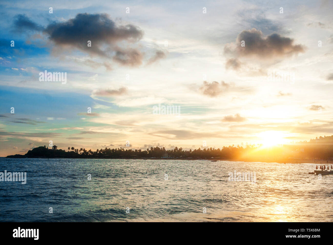 Most popular unawatuna beach on sri lanka, beach with golden sand and palm trees offering activities like snorkeling and scuba diving Stock Photo