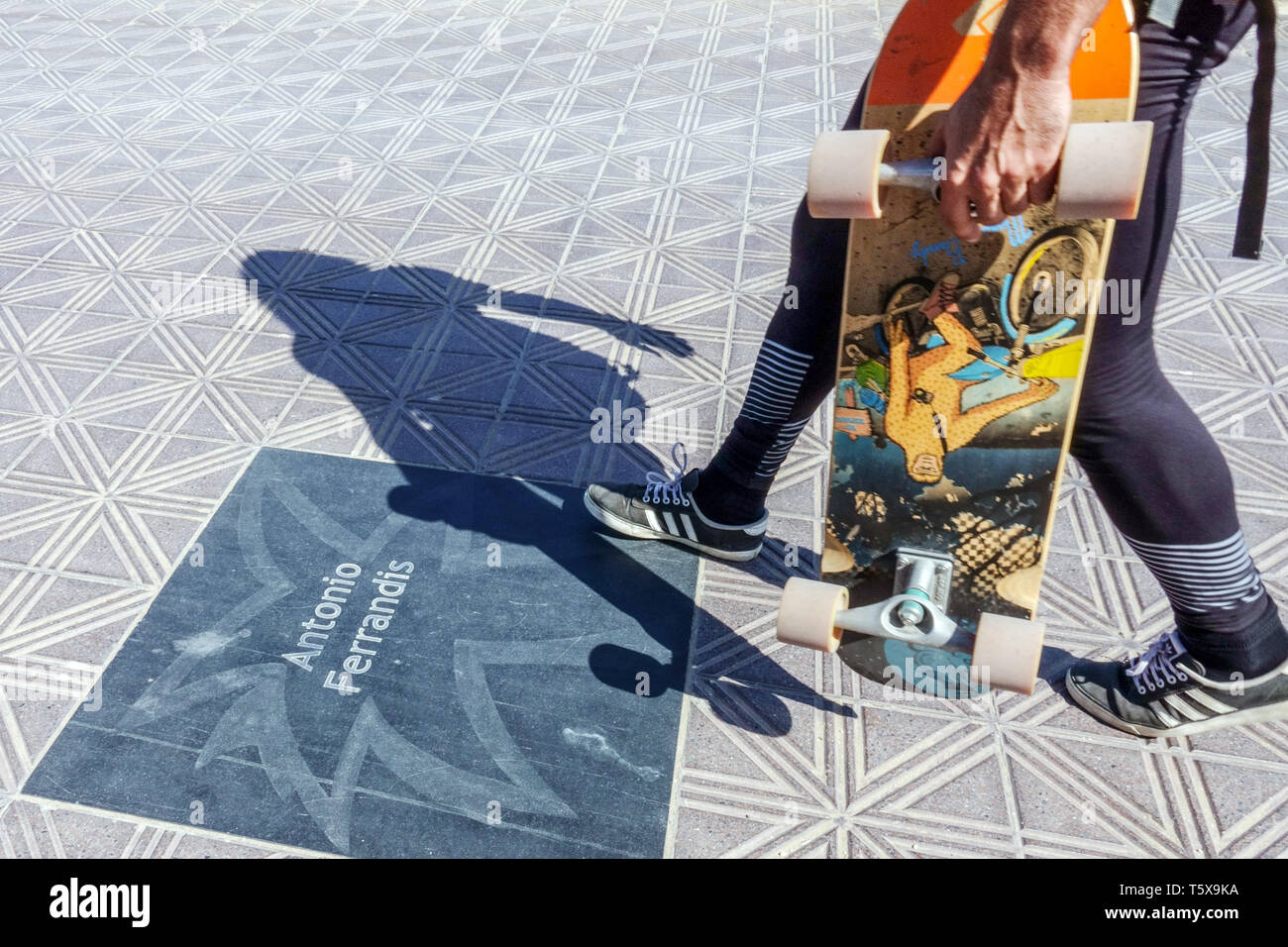 Young man with skateboard on Paseo de La Mostra, El Cabanyal Canyamelar district, Valencia skateboarding Spain Stock Photo