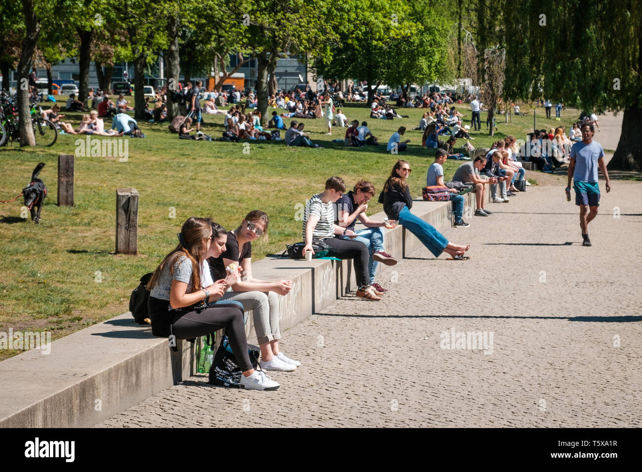 Berlin, Germany - April, 2019: People in Park on a sunny summer day in Berlin, Germany Stock Photo
