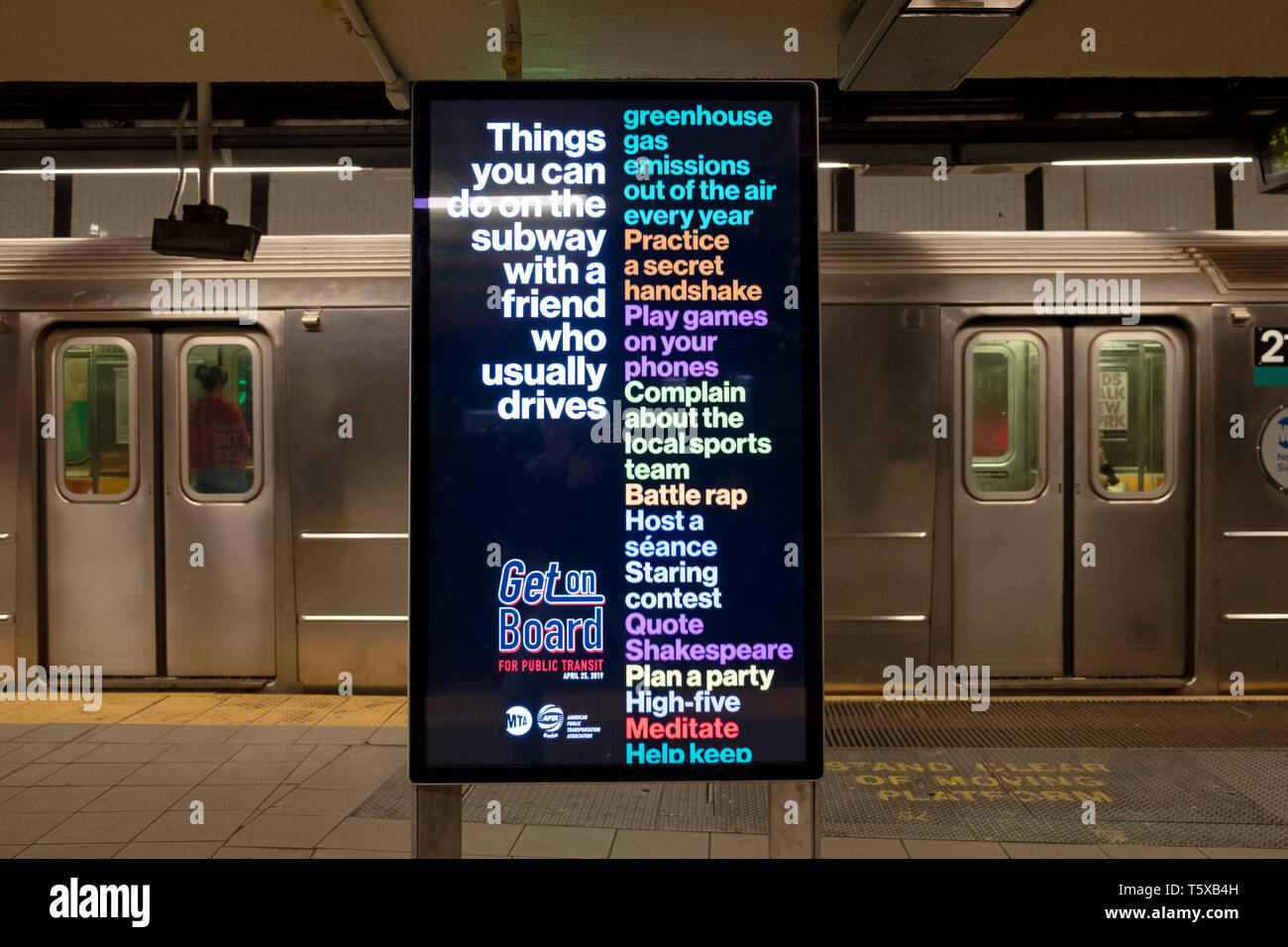 A large electronic sign encouraging people to take public transportation rather than drive. At the Union Square subway station in Manhattan, New York . Stock Photo