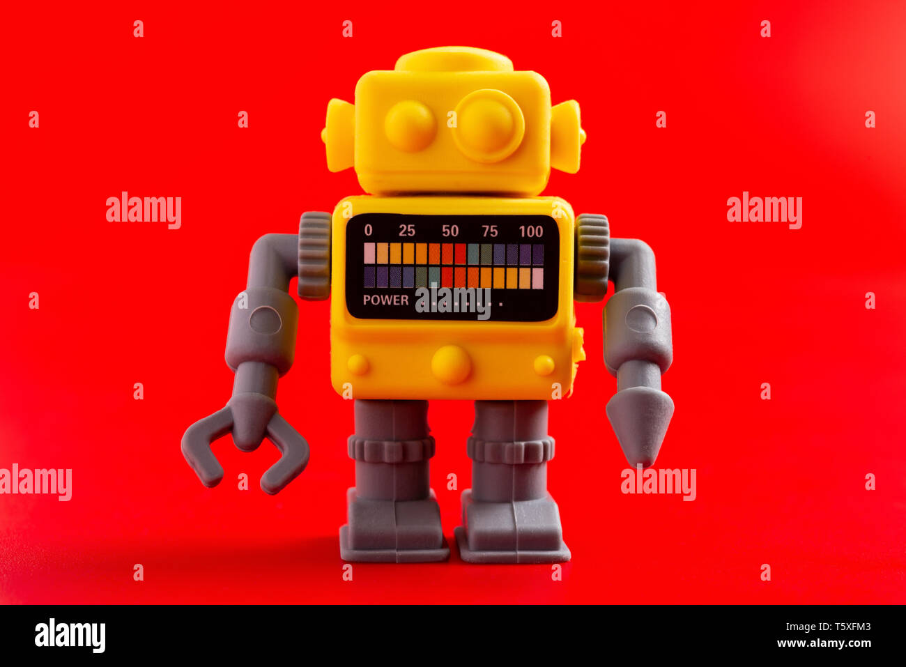 rubber toy robot on a red background Stock Photo