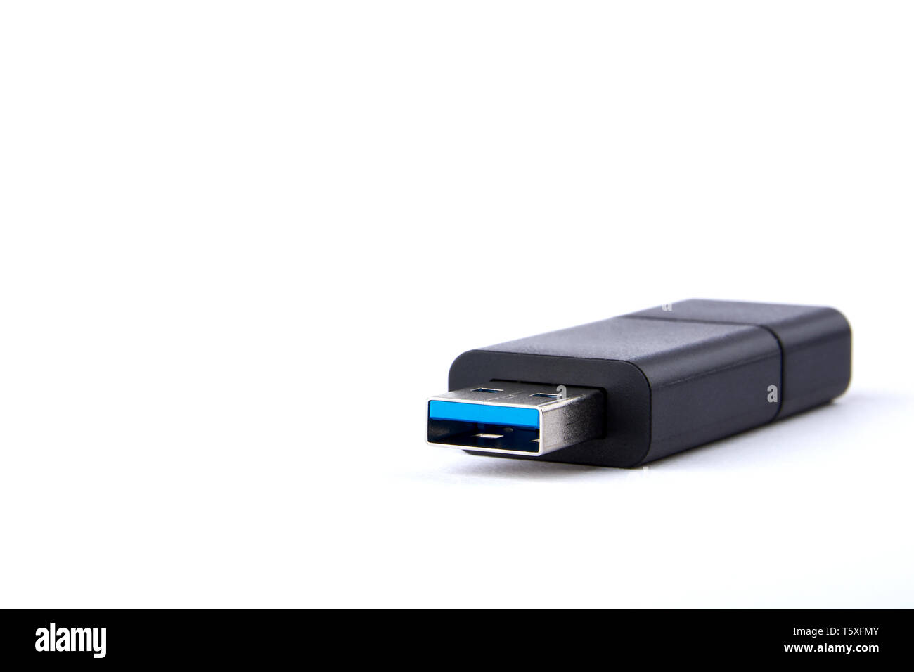Detailed view of black USB flash drive with silver blue connector. Photo on white background with space for your text. Stock Photo