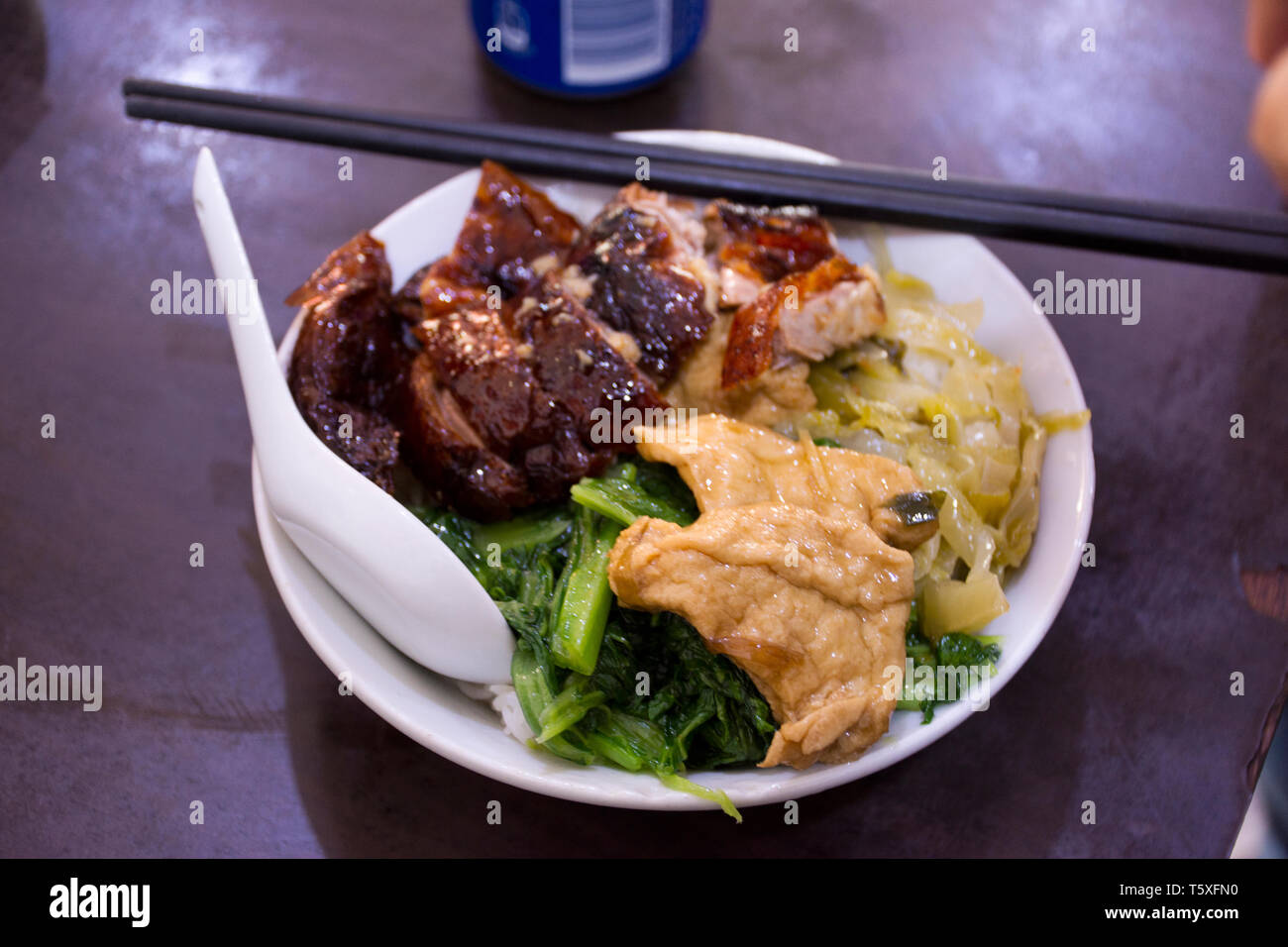 Noodles topping with roast duck and crispy pork and tofu chinese style for sale in local restaurant in Shantou town or Swatow city in Guangdong, China Stock Photo