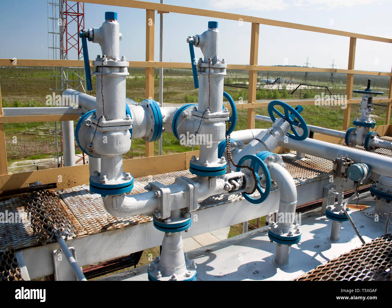 Group valves control the oil production on oil and gas refinery plant. Oil industry Stock Photo