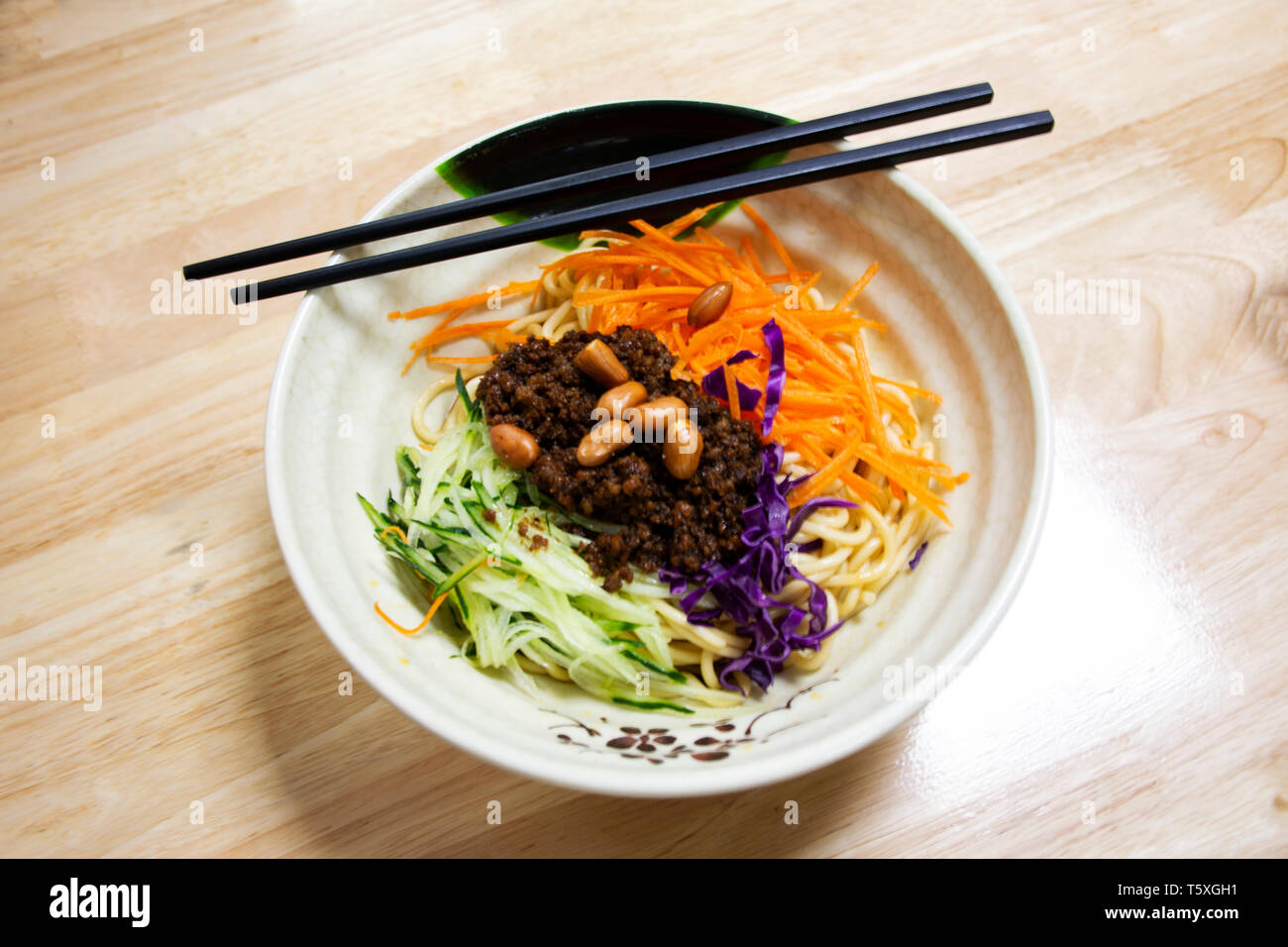 Noodles topping with crispy pork and salad vegetable chinese style for sale in local restaurant in Shantou town or Swatow city in Guangdong, China Stock Photo