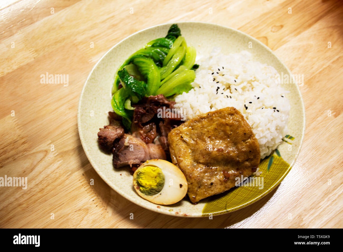 Rice topping roast duck and crispy pork and tofu and boiled egg chinese style for sale in local restaurant in Shantou town or Swatow city in Guangdong Stock Photo