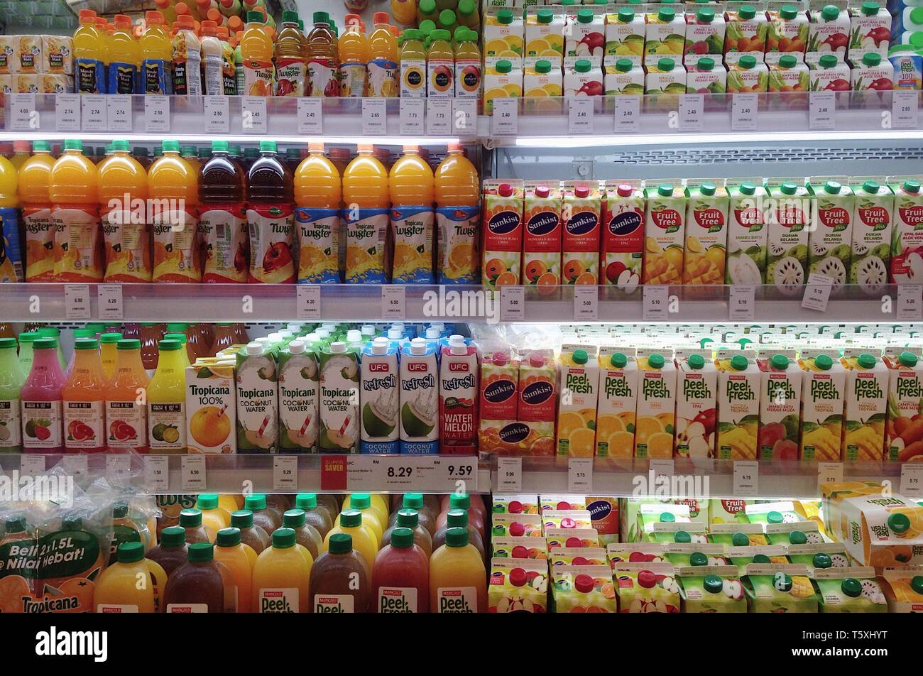 Assorted box and bottle of fresh fruits juices display for sell in