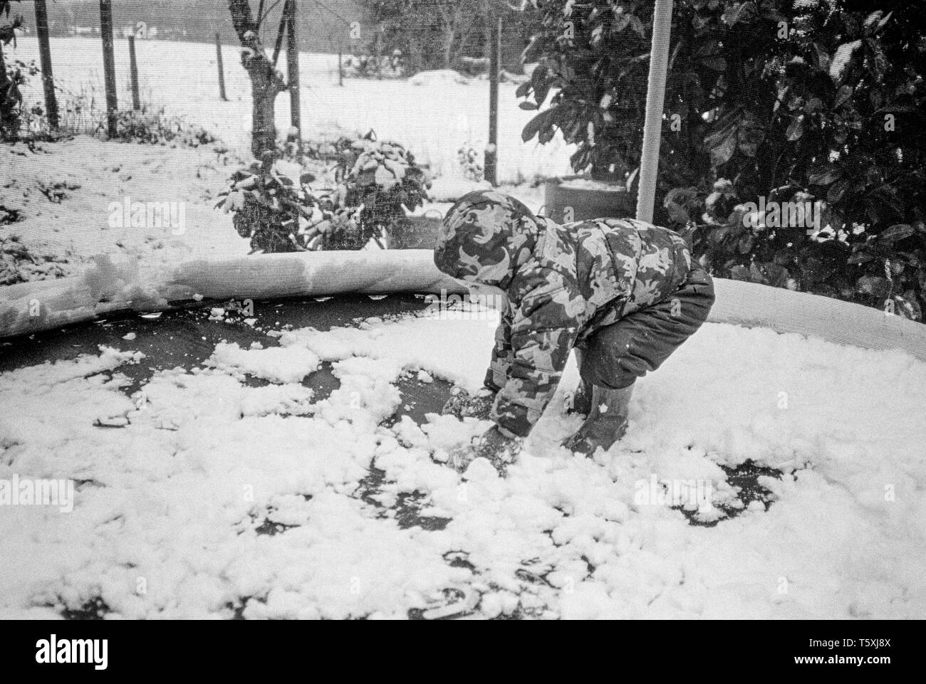 Two year old baby boy in the snow, Medstead, Hampshire, England, United Kingdom. Stock Photo
