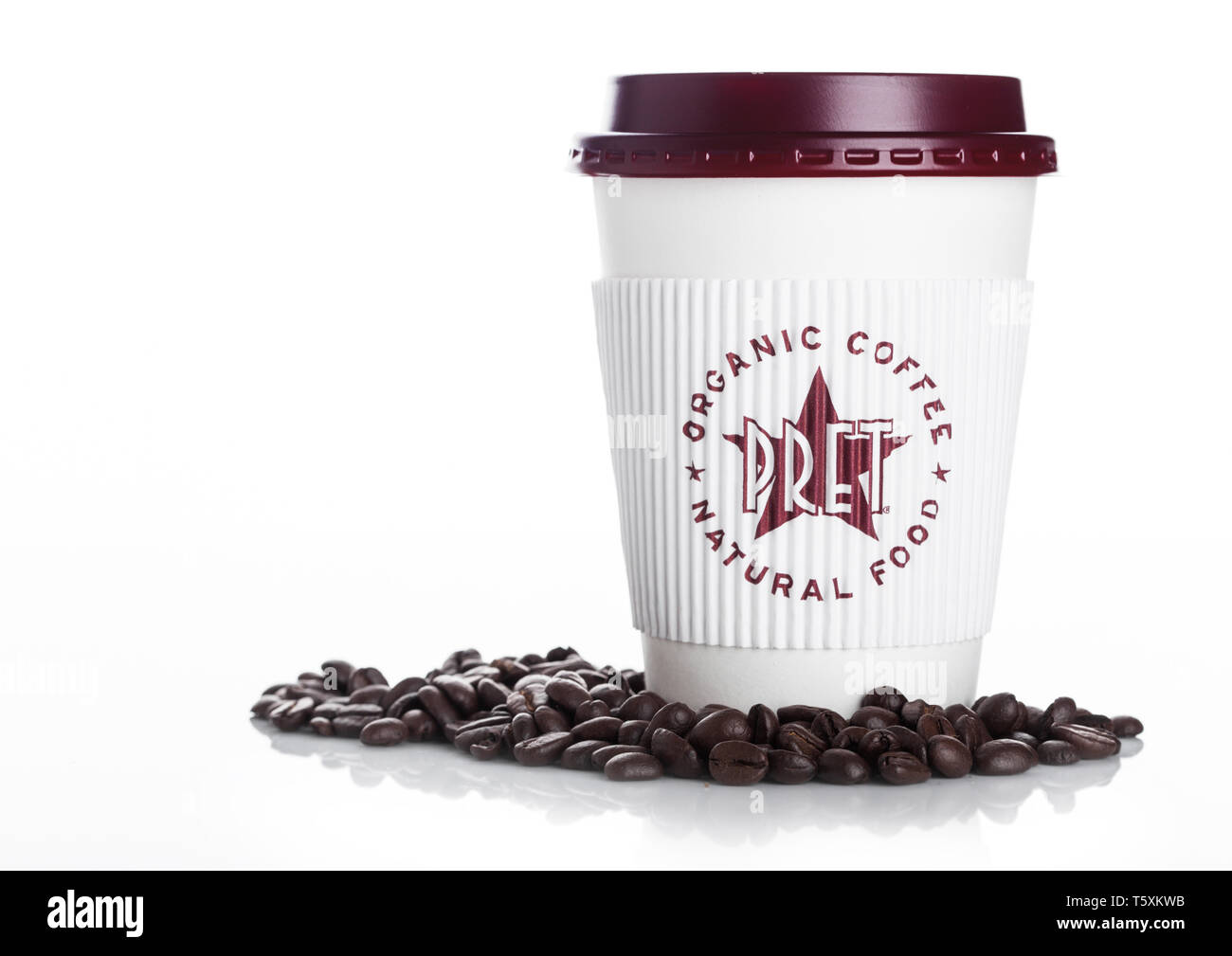 LONDON, UK - APRIL 15, 2019: Pret a Manger Coffee Paper Cup with fresh coffee beans on white. Stock Photo