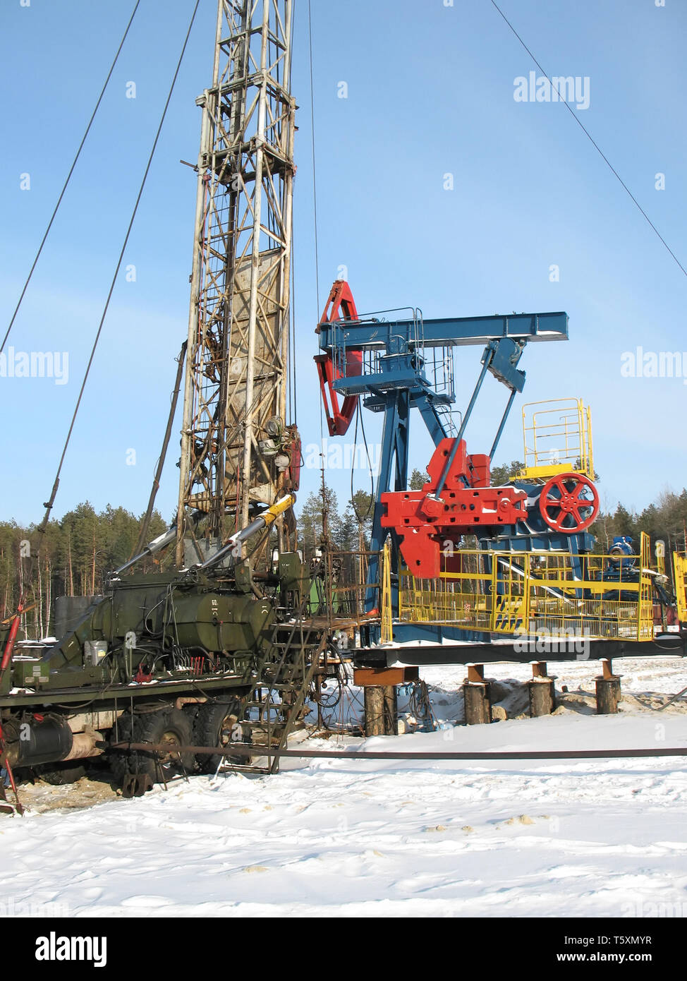 Industrial construction and mechanism. Work of oil industry. Mounting of pipework in wild Siberian taiga. Stock Photo