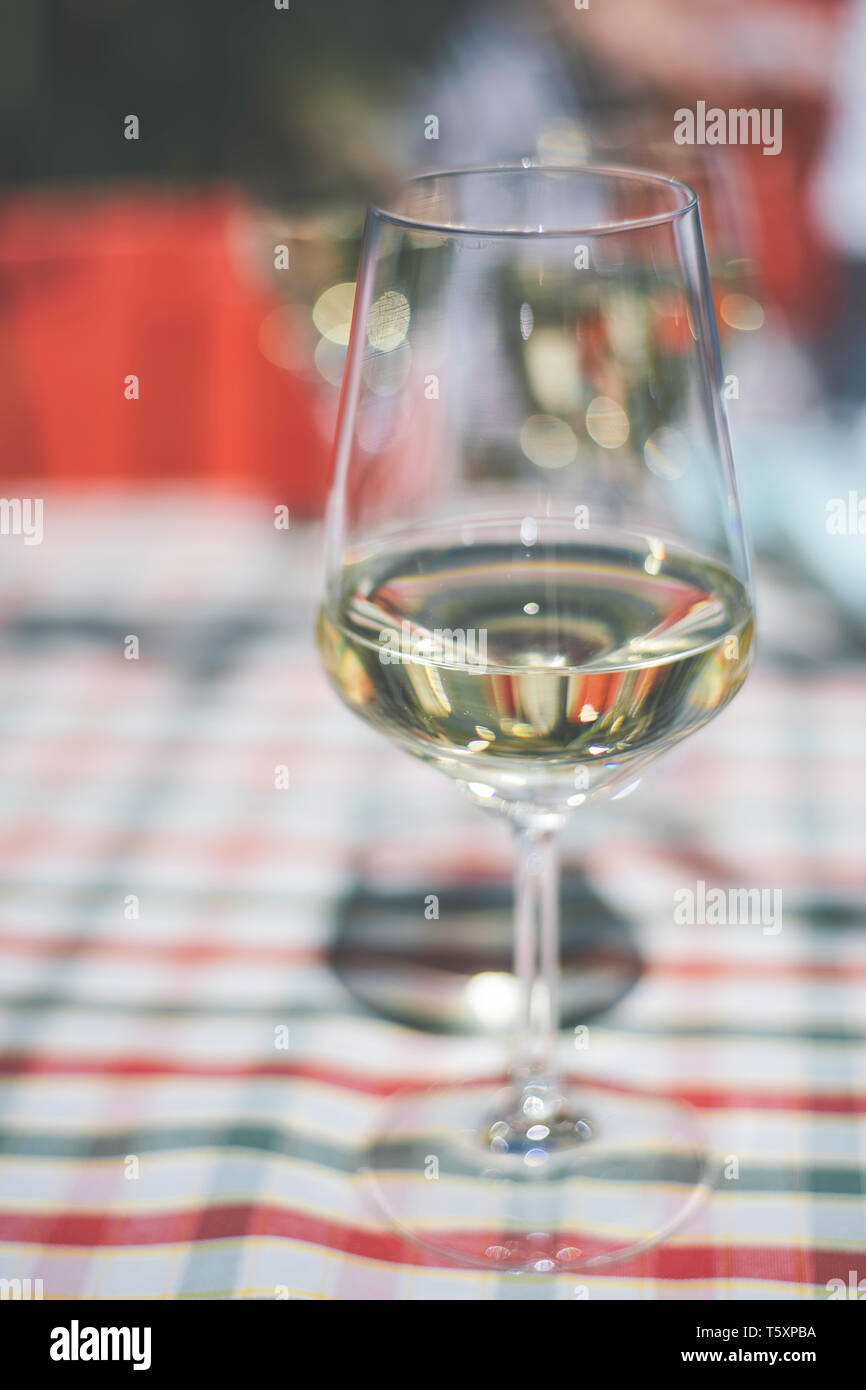 a glass of white wine on the table Stock Photo